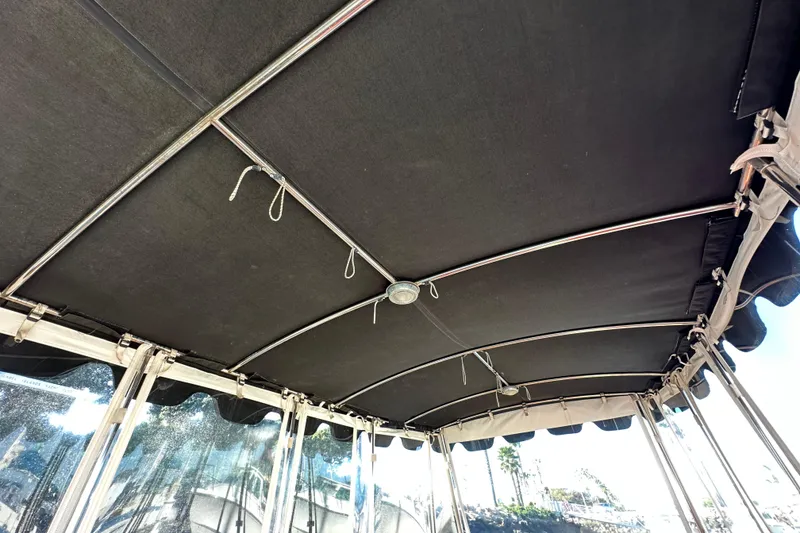 Slide: The Image of Interior view of a 2006 Duffy Cat 16 boat canopy with metal frame and clear side panels. - 21
