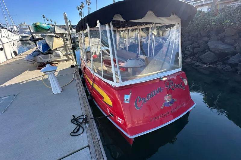 Slide: The Image of Red 2006 Duffy Cat 16 boat docked at marina, clear canopy, sunny day. - 4