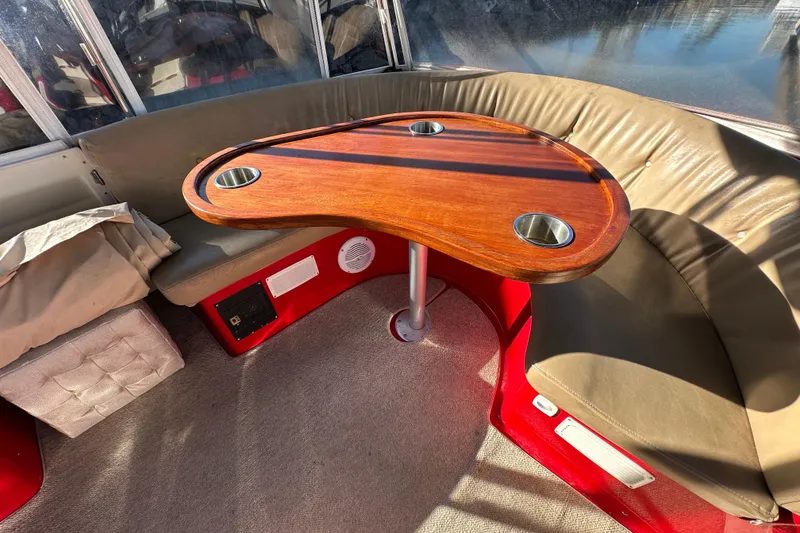 Slide: The Image of Interior of a 2006 Duffy Cat 16 boat with a wooden table and cushioned seating. - 8