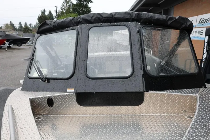 Slide: The Image of 2022 Thunder Jet 185 Luxor boat with covered windshield in a parking lot. - 11