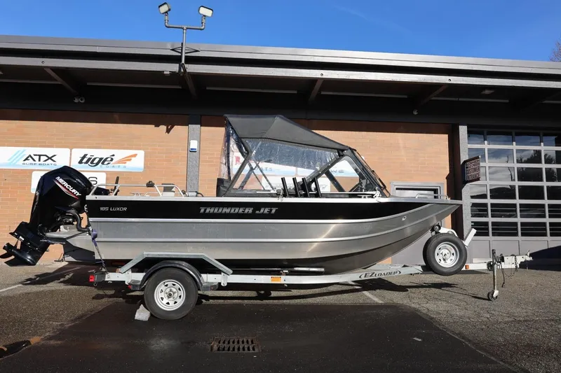 Slide: The Image of 2022 Thunder Jet 185 Luxor boat on trailer, parked outside a building. - 21