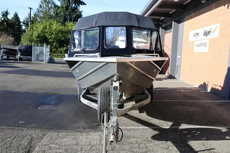 Slide: The Image of 2022 Thunder Jet 185 Luxor boat on trailer, parked outdoors near a building. - 24