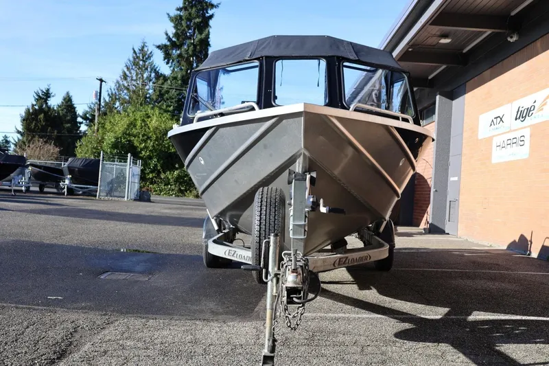 Slide: The Image of 2022 Thunder Jet 185 Luxor boat on trailer, parked outdoors near a building. - 25