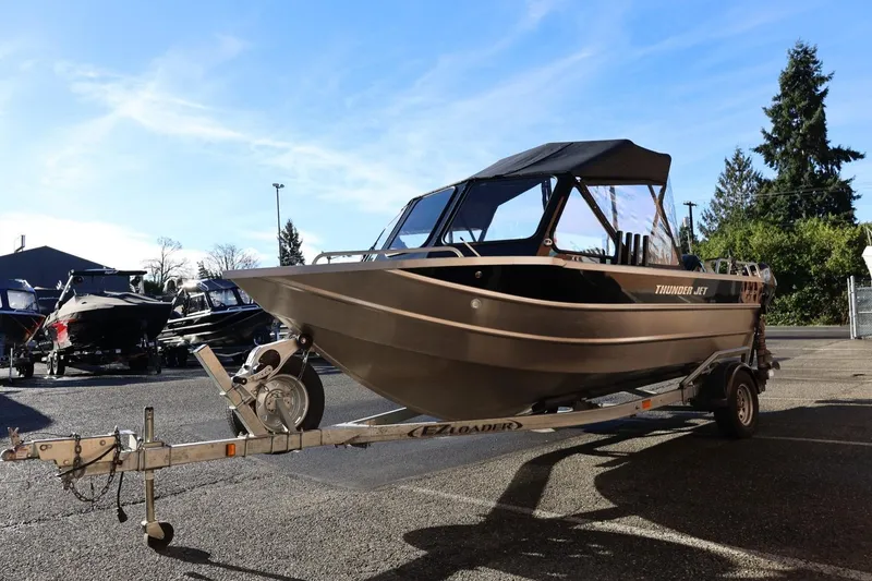Slide: The Image of 2022 Thunder Jet 185 Luxor boat on trailer under clear blue sky. - 27
