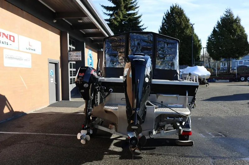Slide: The Image of 2022 Thunder Jet 185 Luxor boat with dual outboard motors, parked outside a dealership. - 29