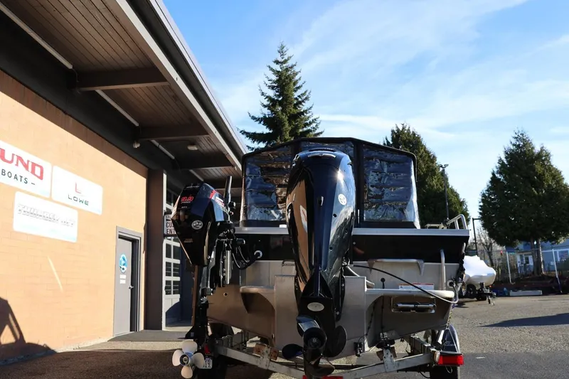Slide: The Image of 2022 Thunder Jet 185 Luxor boat with dual outboard motors, parked outside a building. - 30