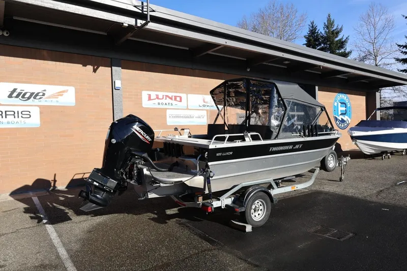 Slide: The Image of 2022 Thunder Jet 185 Luxor boat on trailer, parked outside a marina. - 31