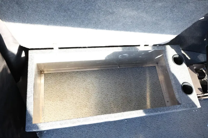 Slide: The Image of 2022 Thunder Jet 185 Luxor storage compartment with carpeted interior and cup holders. - 38