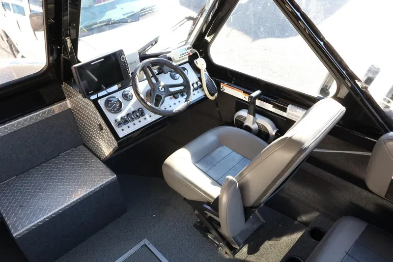 Slide: The Image of 2022 Thunder Jet 185 Luxor boat interior with steering wheel, control panel, and seating. - 42