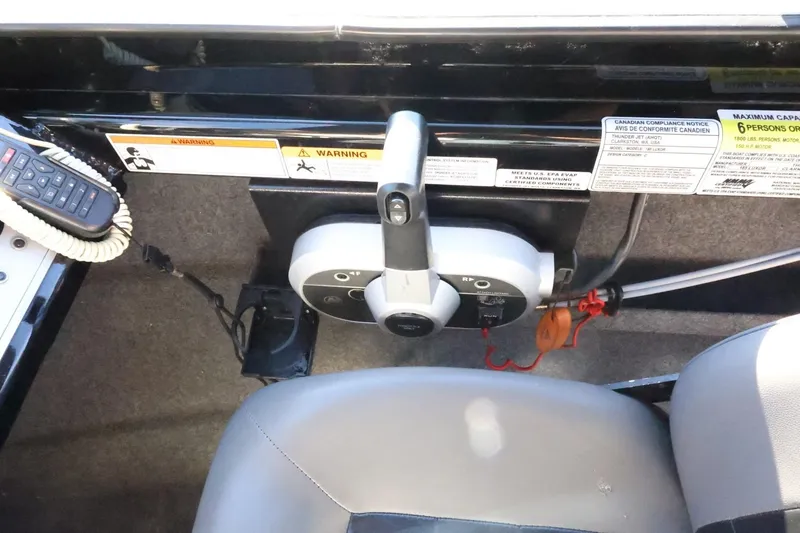 Slide: The Image of Control panel of 2022 Thunder Jet 185 Luxor boat with warning labels and seating. - 48