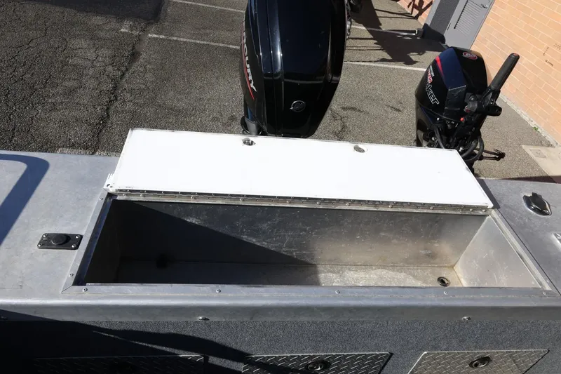 Slide: The Image of 2022 Thunder Jet 185 Luxor boat with open storage compartment and dual Mercury outboard motors. - 53