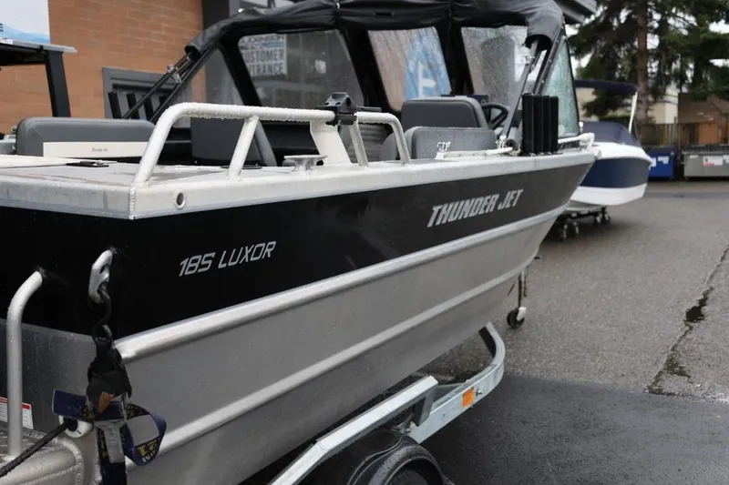 Slide: The Image of 2022 Thunder Jet 185 Luxor with Mercury outboard engine, wet with raindrops. - 6
