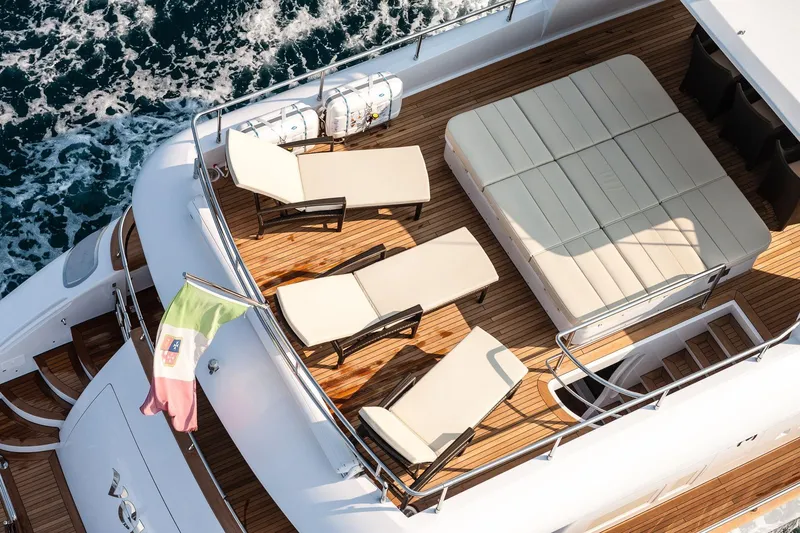 Slide: The Image of Luxurious 2012 Maiora yacht deck with sun loungers and seating, cruising on the ocean. - 3