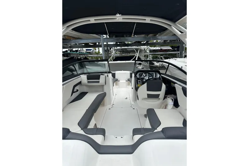 Slide: The Image of 2021 Yamaha Boats AR210 interior with sleek seating and modern dashboard. - 4