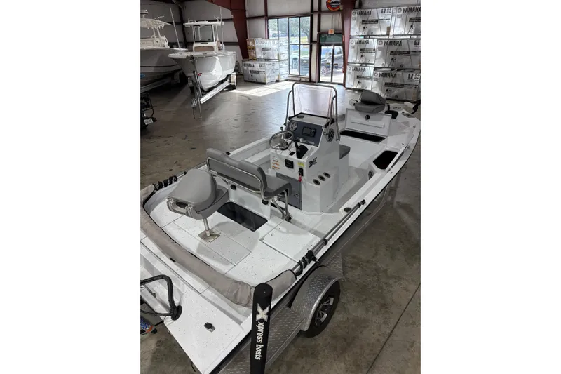 Slide: The Image of 2022 Express H20 Bay boat in showroom, featuring sleek design and modern controls. - 10
