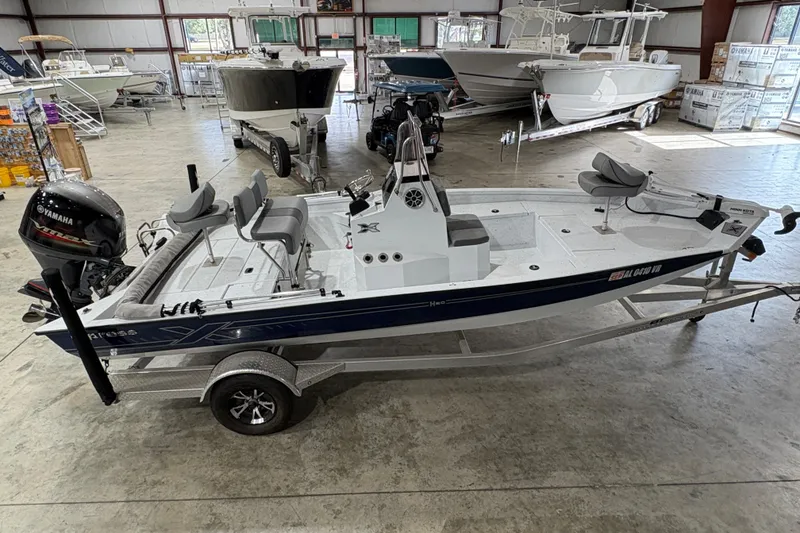 Slide: The Image of 2022 Express H20 Bay boat in showroom, featuring Yamaha outboard motor. - 11