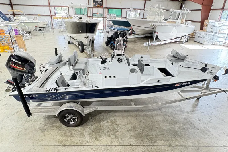Slide: The Image of 2022 Express H20 Bay boat in showroom, featuring Yamaha outboard motor. - 12