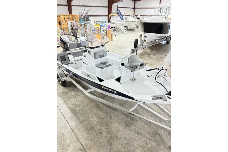 Slide: The Image of 2022 Express H20 Bay boat displayed indoors, featuring seating and control console. - 14