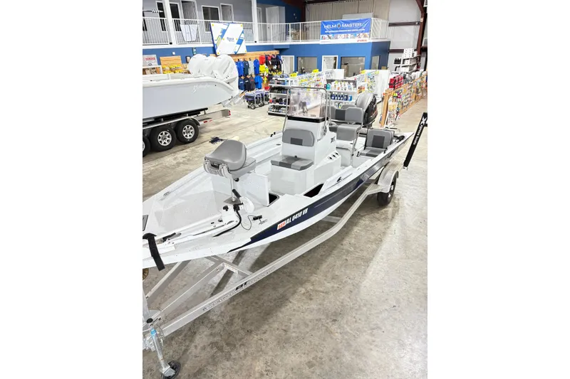 Slide: The Image of 2022 Express H20 Bay boat displayed in a showroom with various marine accessories. - 15