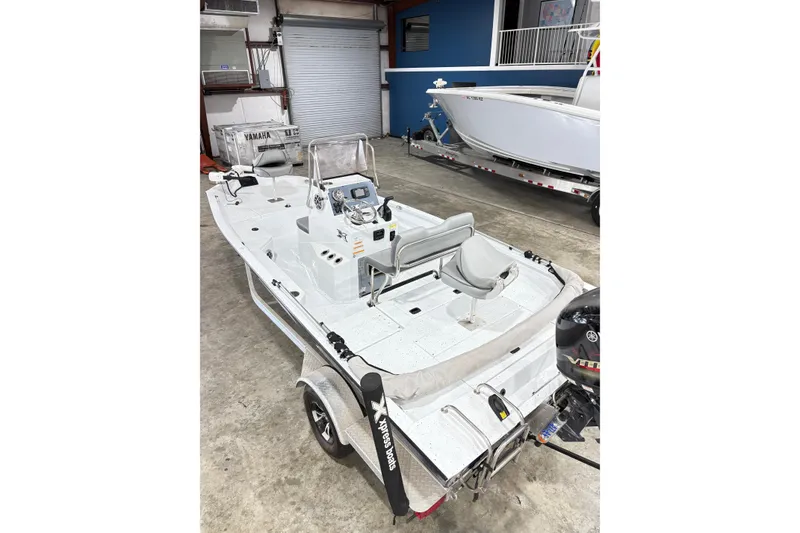 Slide: The Image of 2022 Express H20 Bay boat in garage, featuring Yamaha engine and modern design. - 17