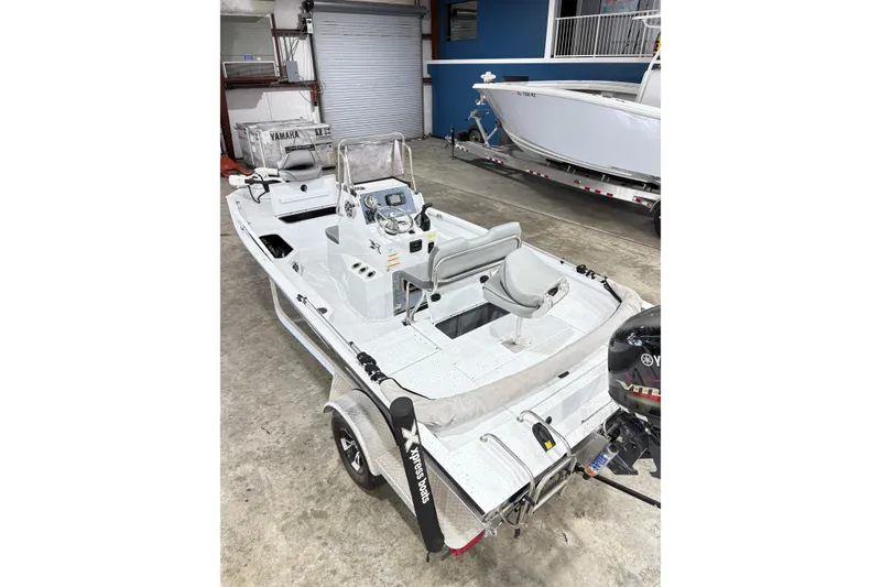 Slide: The Image of 2022 Express H20 Bay boat with Yamaha motor in a garage setting. - 18