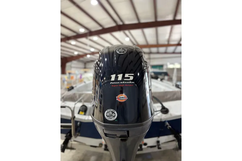 Slide: The Image of 2022 Express H20 Bay boat with 115 horsepower outboard motor in a warehouse. - 20