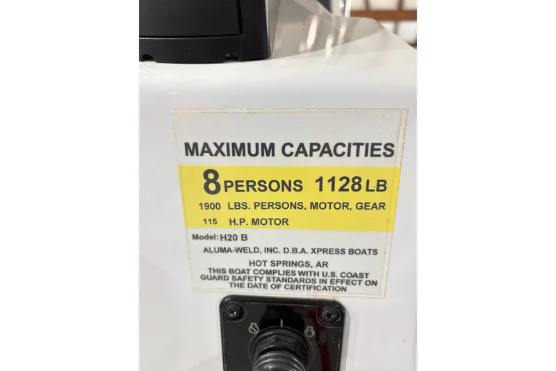 Slide: The Image of 2022 Express H20 Bay boat capacity label, 8 persons, 1128 lbs, 115 HP motor. - 22