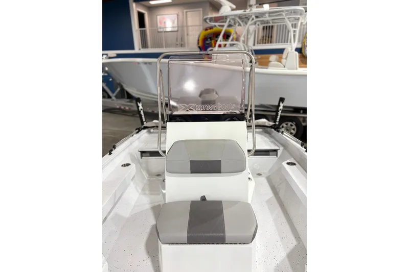 Slide: The Image of 2022 Express H20 Bay boat interior with seating and console in showroom. - 23