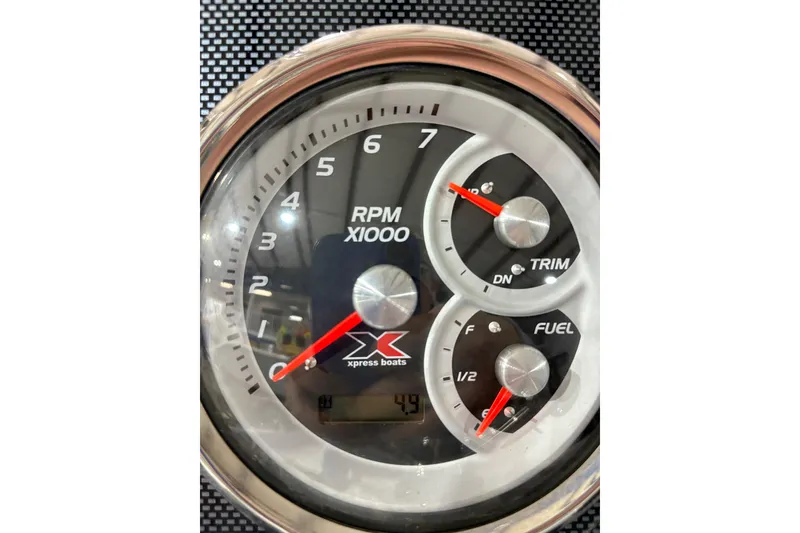 Slide: The Image of Close-up of 2022 Express H20 Bay boat dashboard gauges showing RPM, trim, and fuel levels. - 24
