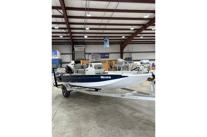 Slide: The Image of 2022 Express H20 Bay boat displayed indoors on a trailer. - 4