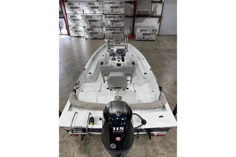 Slide: The Image of 2022 Express H20 Bay boat with Yamaha 115 engine in warehouse setting. - 7