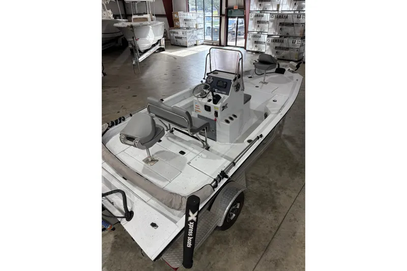 Slide: The Image of 2022 Express H20 Bay boat in showroom, featuring sleek design and modern controls. - 9