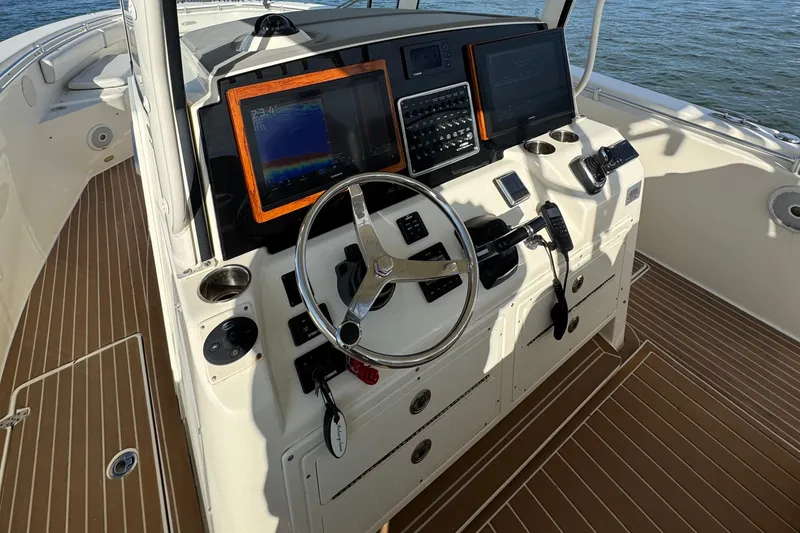 Slide: The Image of 2015 Cobia 344 Center Console boat helm with modern navigation equipment. - 17