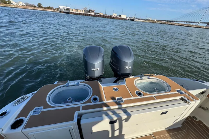 Slide: The Image of 2015 Cobia 344 Center Console boat with dual Yamaha 300 engines on water. - 21