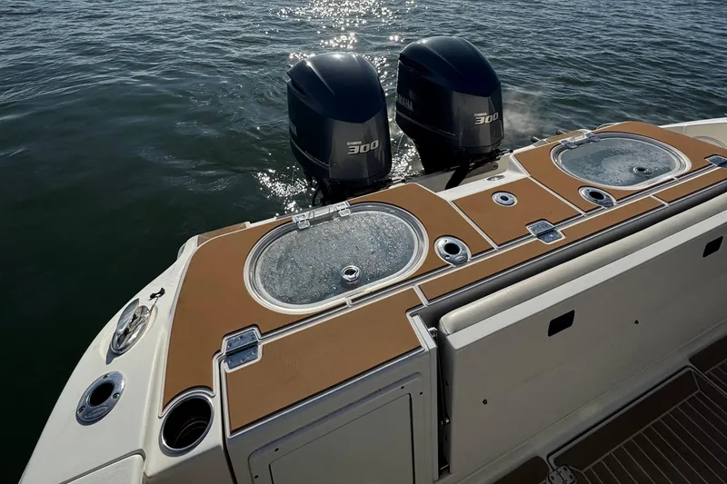 Slide: The Image of 2015 Cobia 344 Center Console boat with twin Yamaha 300 engines on water. - 22