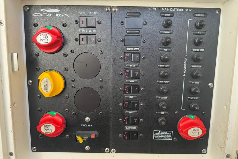 Slide: The Image of Control panel of a 2015 Cobia 344 Center Console boat with switches and labels. - 23