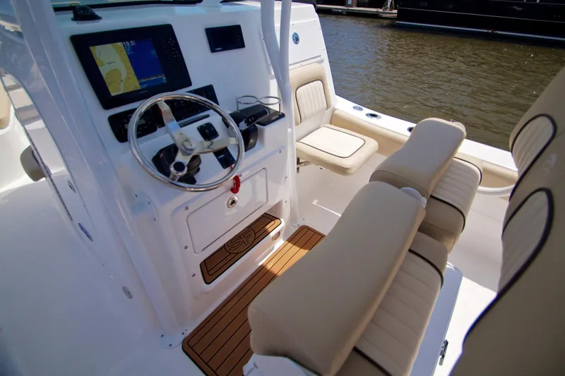 Slide: The Image of Manufacturer Provided Image: 2016 Sea Fox 249 Avenger boat interior with steering wheel and seating. - 11