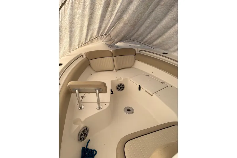 Slide: The Image of 2016 Sea Fox 249 Avenger boat interior with beige seating and storage compartments. - 17