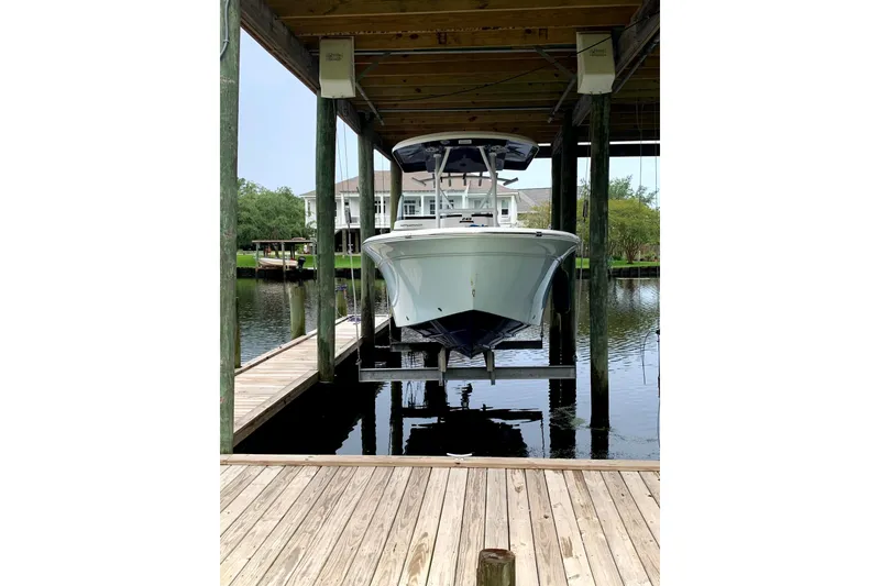Slide: The Image of 2016 Sea Fox 249 Avenger boat docked in a covered marina. - 3