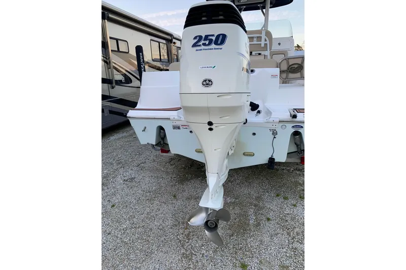 Slide: The Image of 2016 Sea Fox 249 Avenger with 250 horsepower outboard motor, parked on gravel. - 4