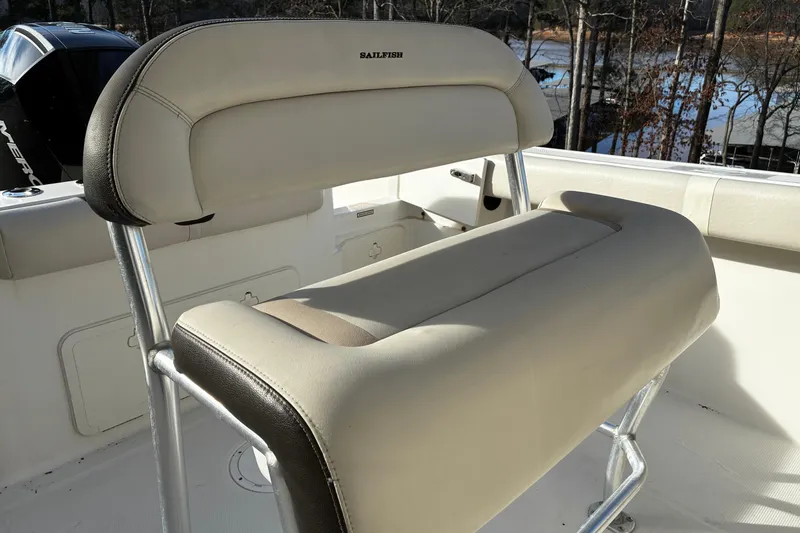 Slide: The Image of 2022 Sailfish 242 CC boat interior with cushioned seating and console. - 10