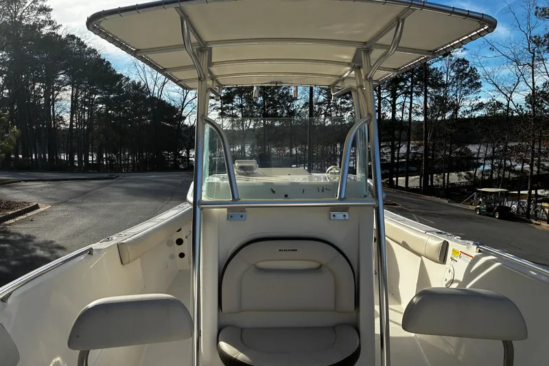 Slide: The Image of 2022 Sailfish 242 CC boat interior with cushioned seating and steering wheel. - 12