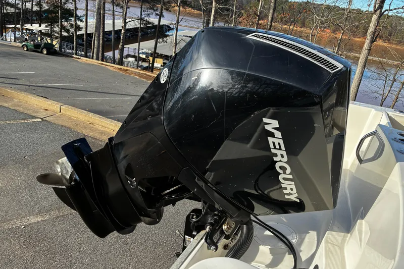 Slide: The Image of Open livewell on 2022 Sailfish 242 CC boat, showing interior and lid design. - 15