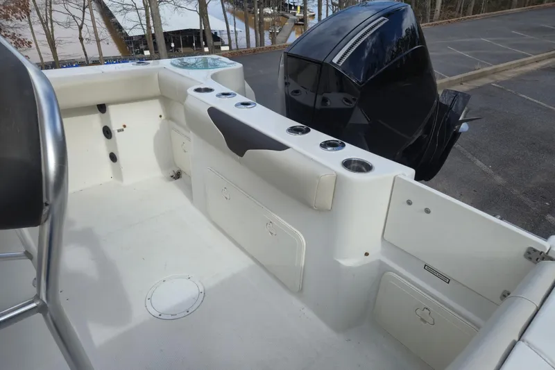 Slide: The Image of 2022 Sailfish 242 CC boat interior with seating and outboard motor. - 18