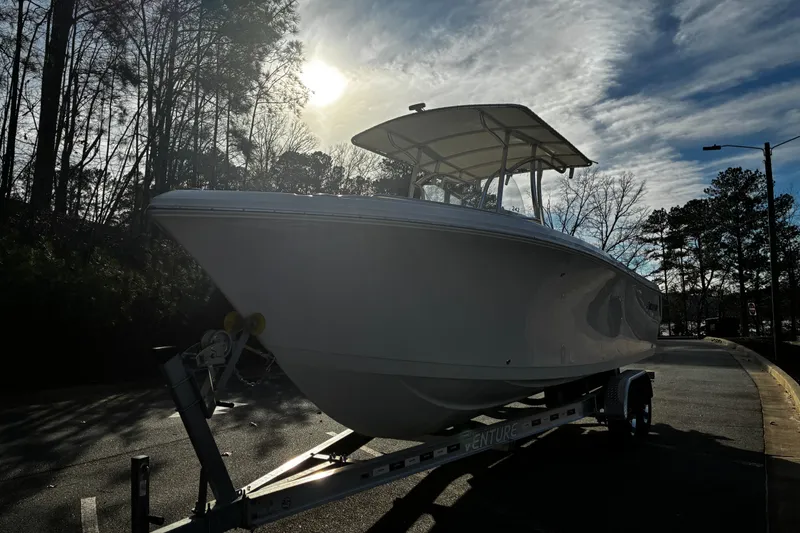 Slide: The Image of 2022 Sailfish 242 CC boat console with Garmin navigation system and steering wheel. - 6