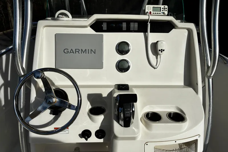 Slide: The Image of 2022 Sailfish 242 CC boat interior with cushioned seating and storage. - 8