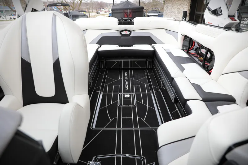 Slide: The Image of 2026 Centurion Ri245 boat interior with sleek black and white seating design. - 10