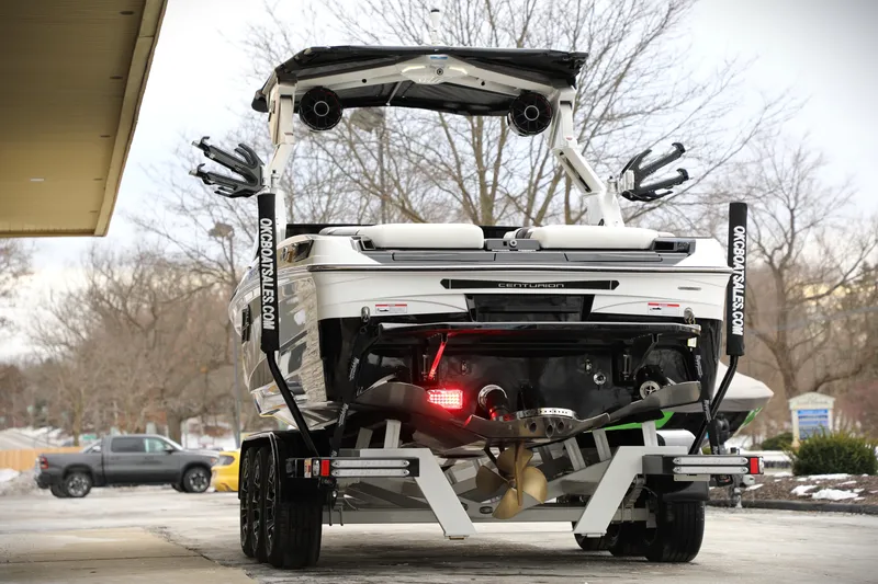 Slide: The Image of 2026 Centurion Ri245 boat on trailer, rear view, showcasing sleek design and advanced features. - 15