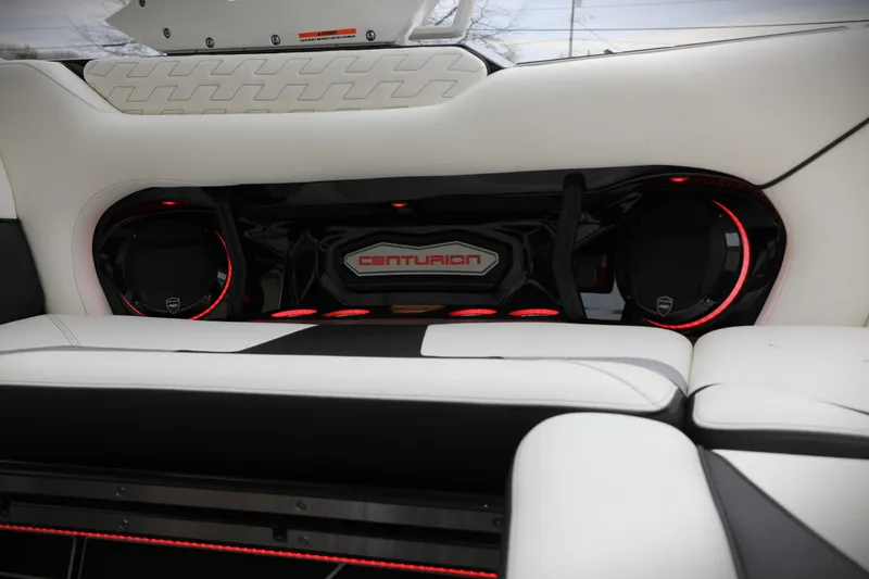 Slide: The Image of 2026 Centurion Ri245 boat interior with sleek white seating and illuminated audio system. - 18