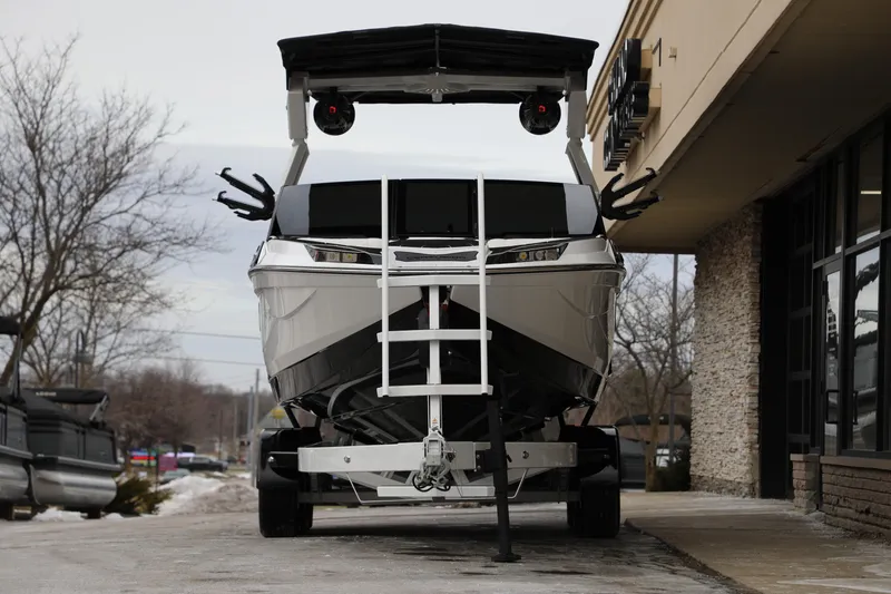 Slide: The Image of 2026 Centurion Ri245 boat on trailer outside a building, showcasing modern design. - 4